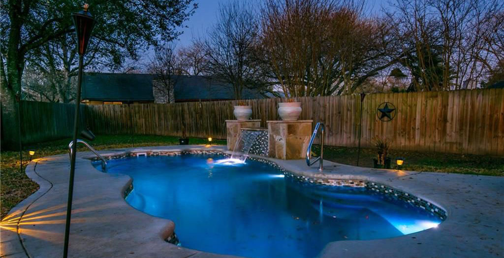 Lonestar inground fiberglass pools San Antonio manufactures the free form Santa Fe model pool custom water feature for backyard oasis