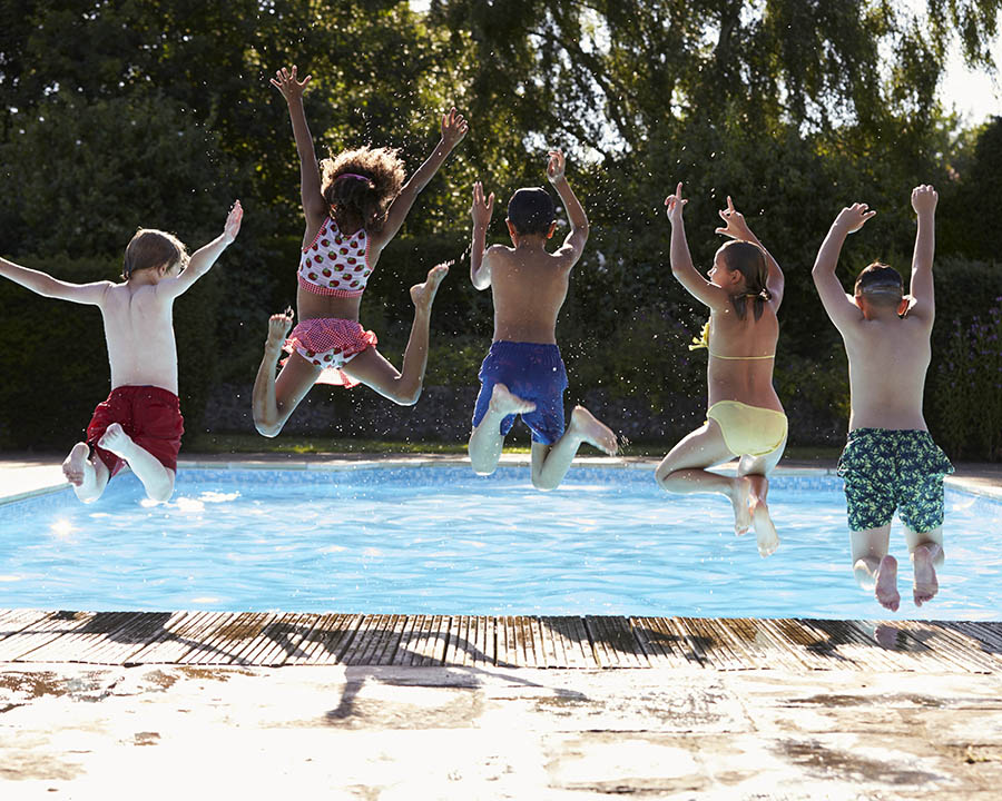 Swimming Fiberglass Pools Metairie Louisiana Miami Style Pool Rear View Of Children Jumping In and having fun in a private backyard oasis